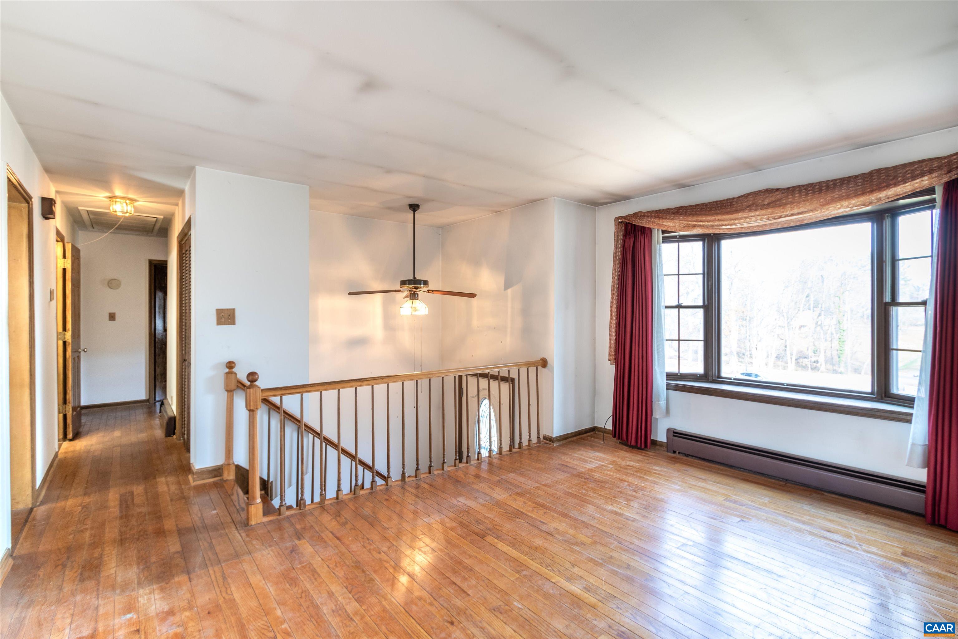 187 Warmar Road Ruckersville, VA 22968 - Photo 11 of 35 an empty room with wooden floor and windows