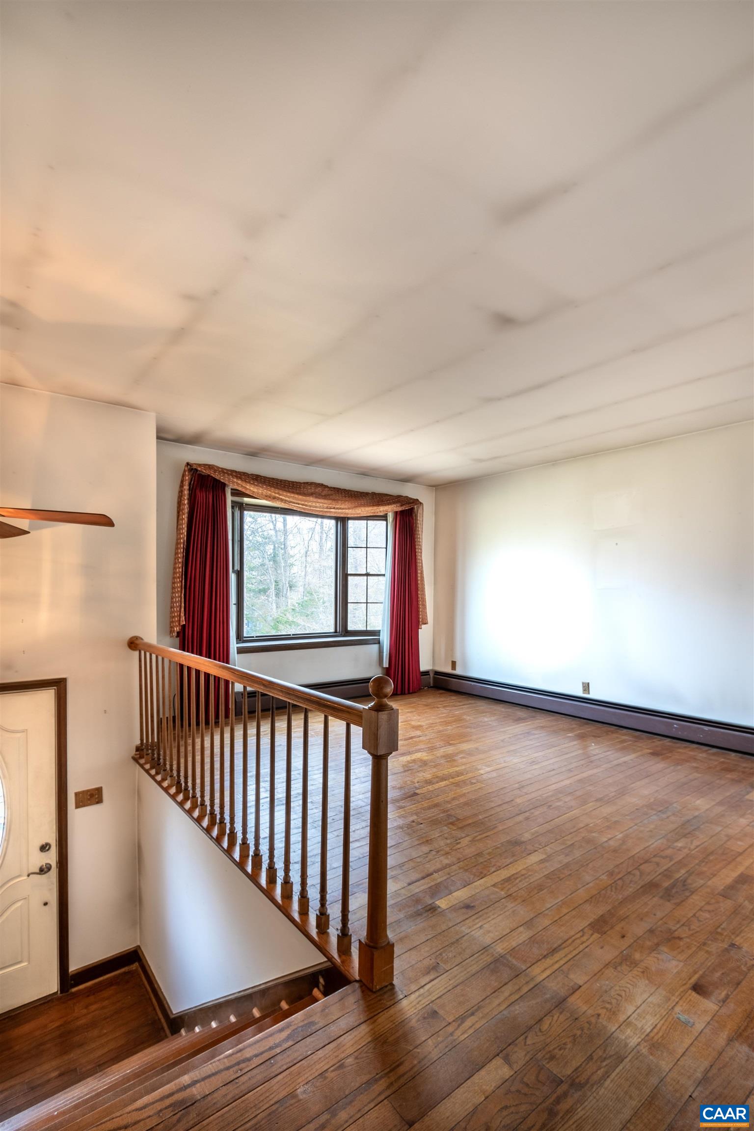 187 Warmar Road Ruckersville, VA 22968 - Photo 14 of 35 a view of an empty room with wooden floor and a window