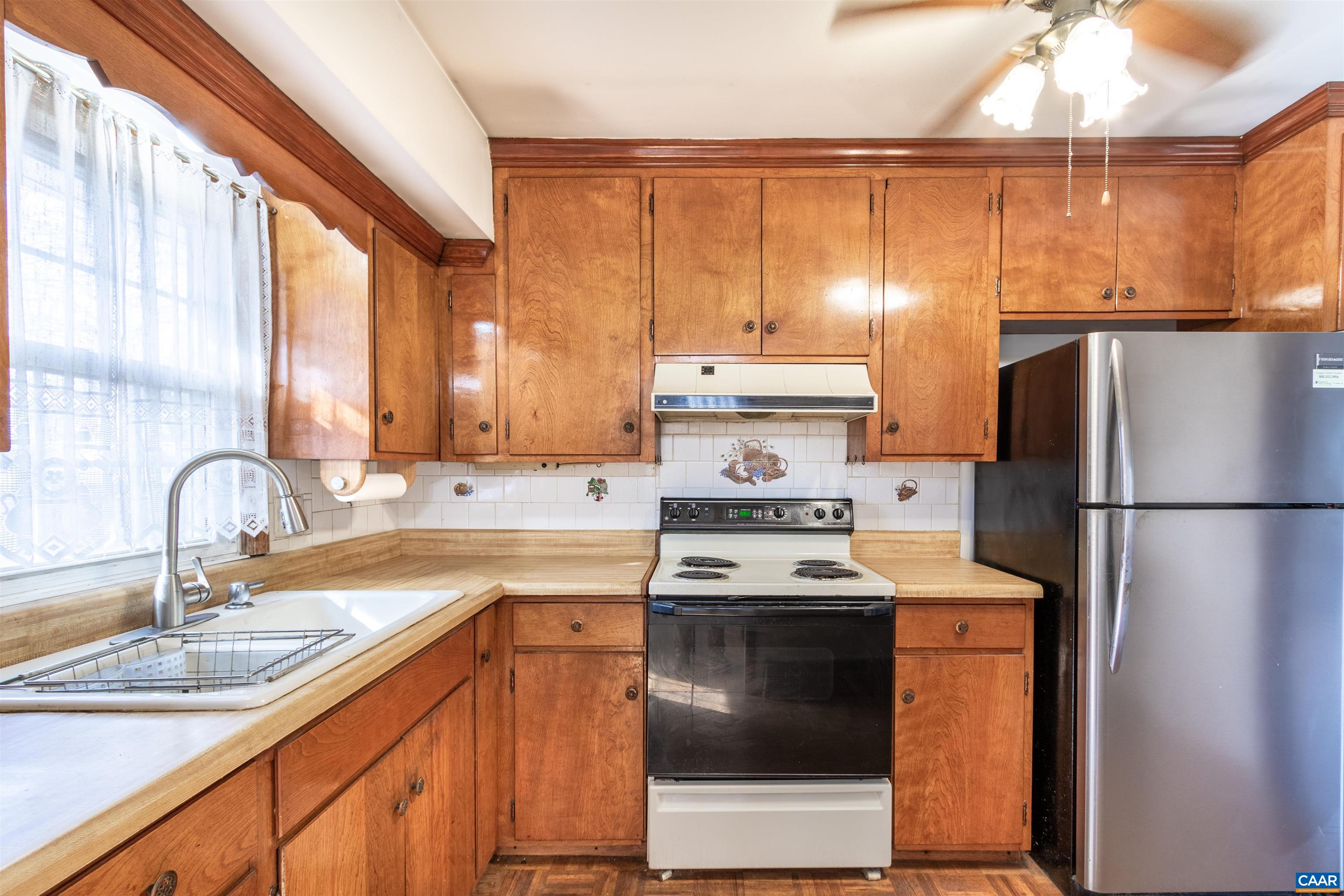 187 Warmar Road Ruckersville, VA 22968 - Photo 16 of 35 a kitchen with a sink a refrigerator and a stove