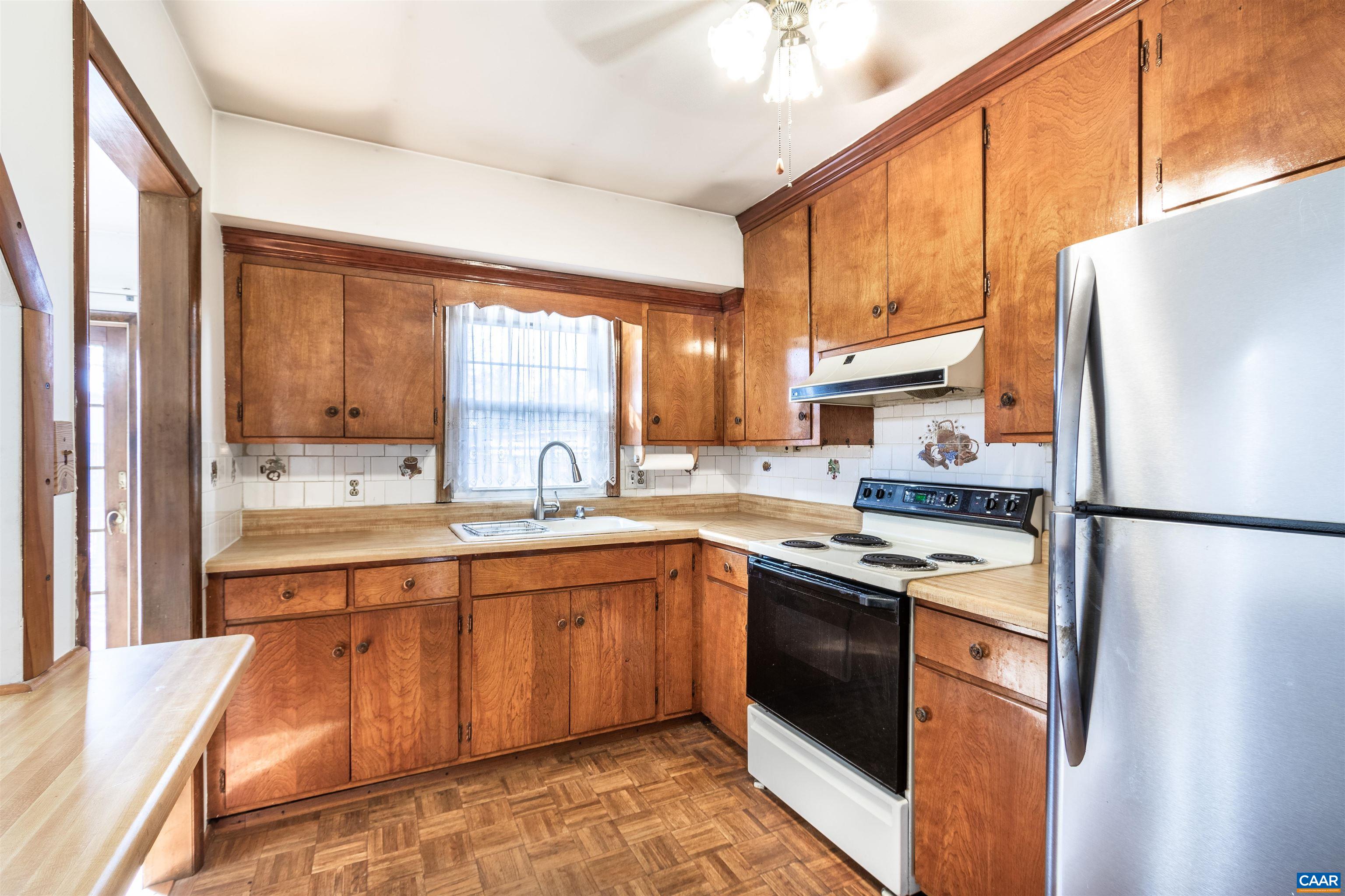 187 Warmar Road Ruckersville, VA 22968 - Photo 17 of 35 a kitchen with stainless steel appliances granite countertop a refrigerator a sink dishwasher a stove with wooden cabinets and floor