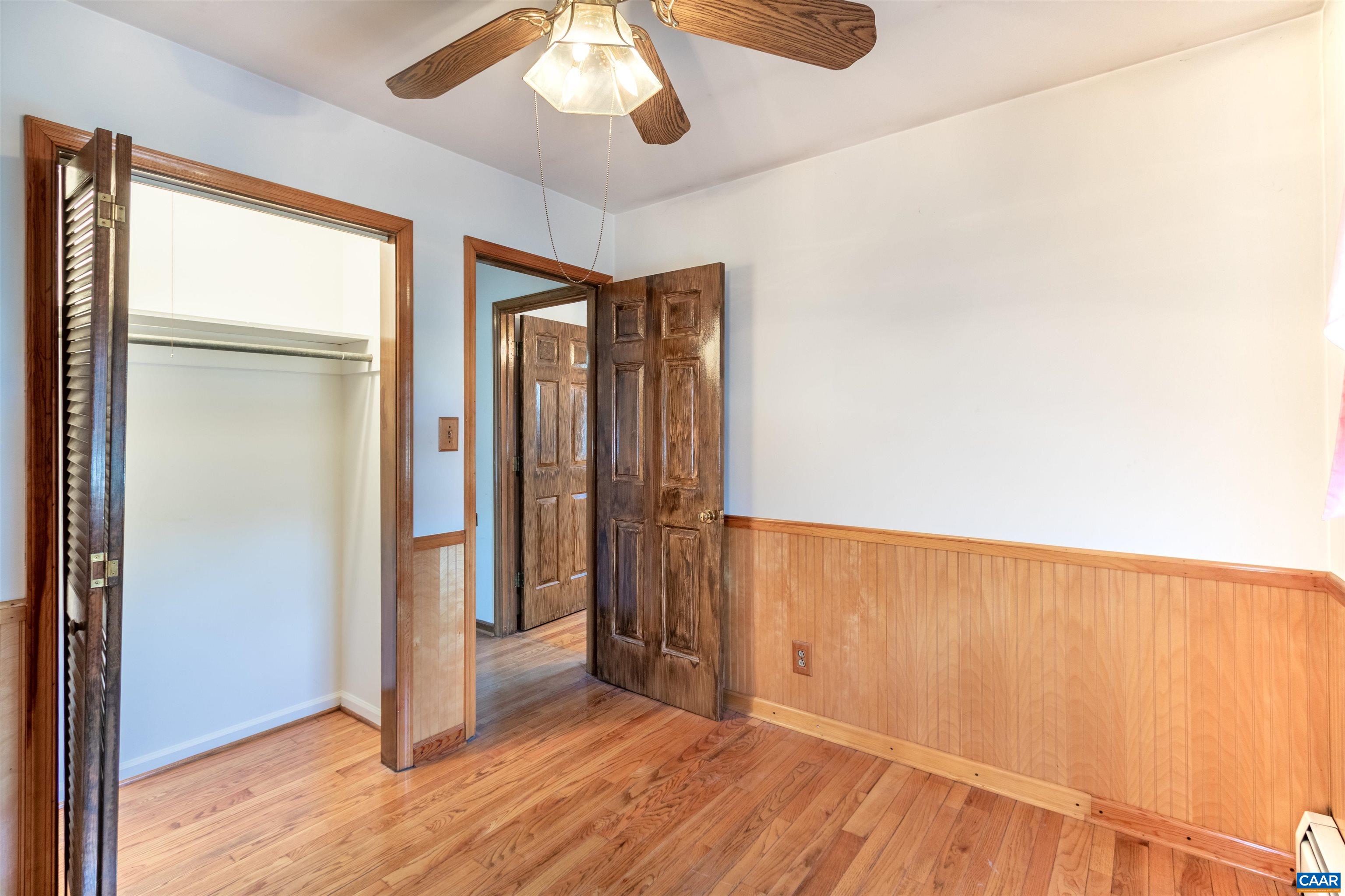 187 Warmar Road Ruckersville, VA 22968 - Photo 19 of 35 an empty room with wooden floor fan and windows