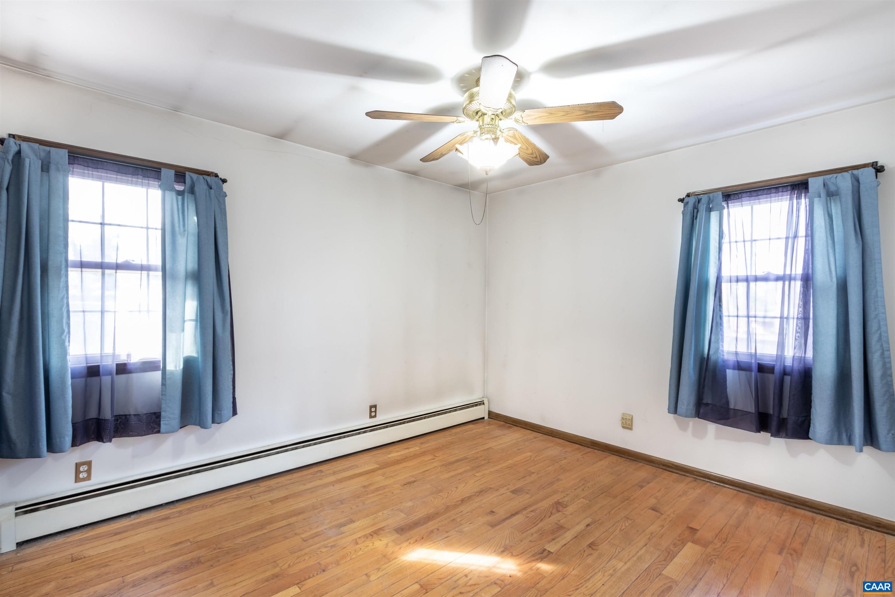 187 Warmar Road Ruckersville, VA 22968 - Photo 26 of 35 an empty room with wooden floor fan and windows