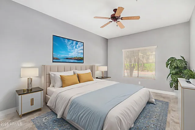 a bedroom with a bed and a chandelier