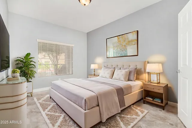 a bedroom with a bed and a potted plant