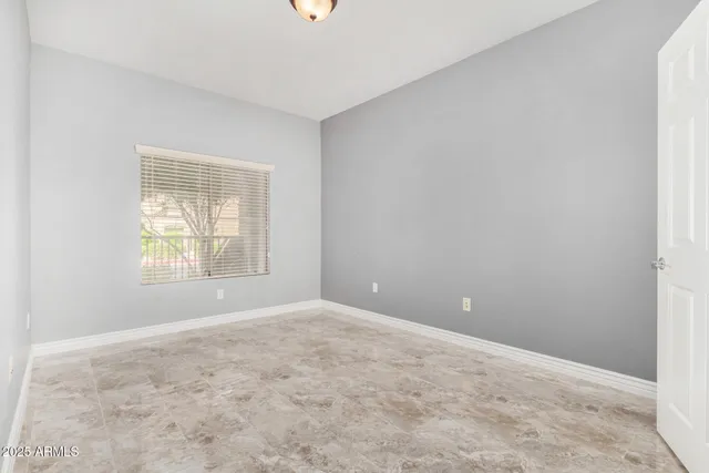 an empty room with windows and closet