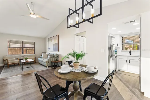 a view of a dining room with furniture and wooden floor