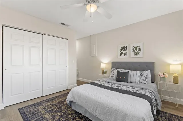 a bedroom with a large bed and a chandelier