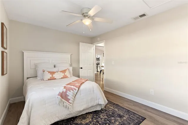a bedroom with a large bed and a chandelier