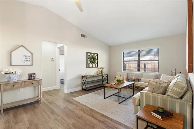 a living room with furniture and a wooden floor