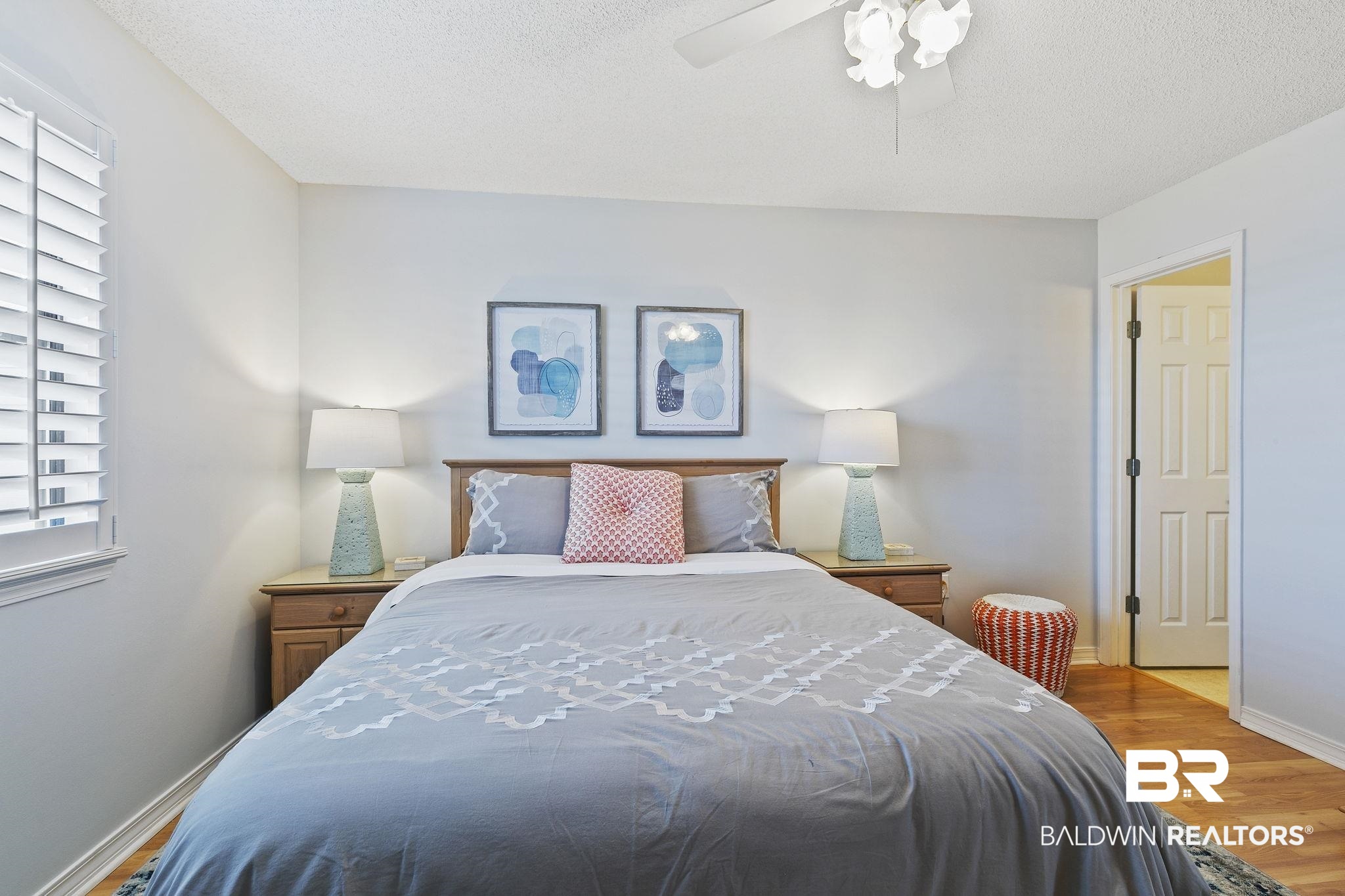 25861 Canal Road, Unit 78 Orange Beach, AL 36561 - Photo 23 of 45 Bedroom featuring baseboards, a textured ceiling, wood finished floors, and a ceiling fan