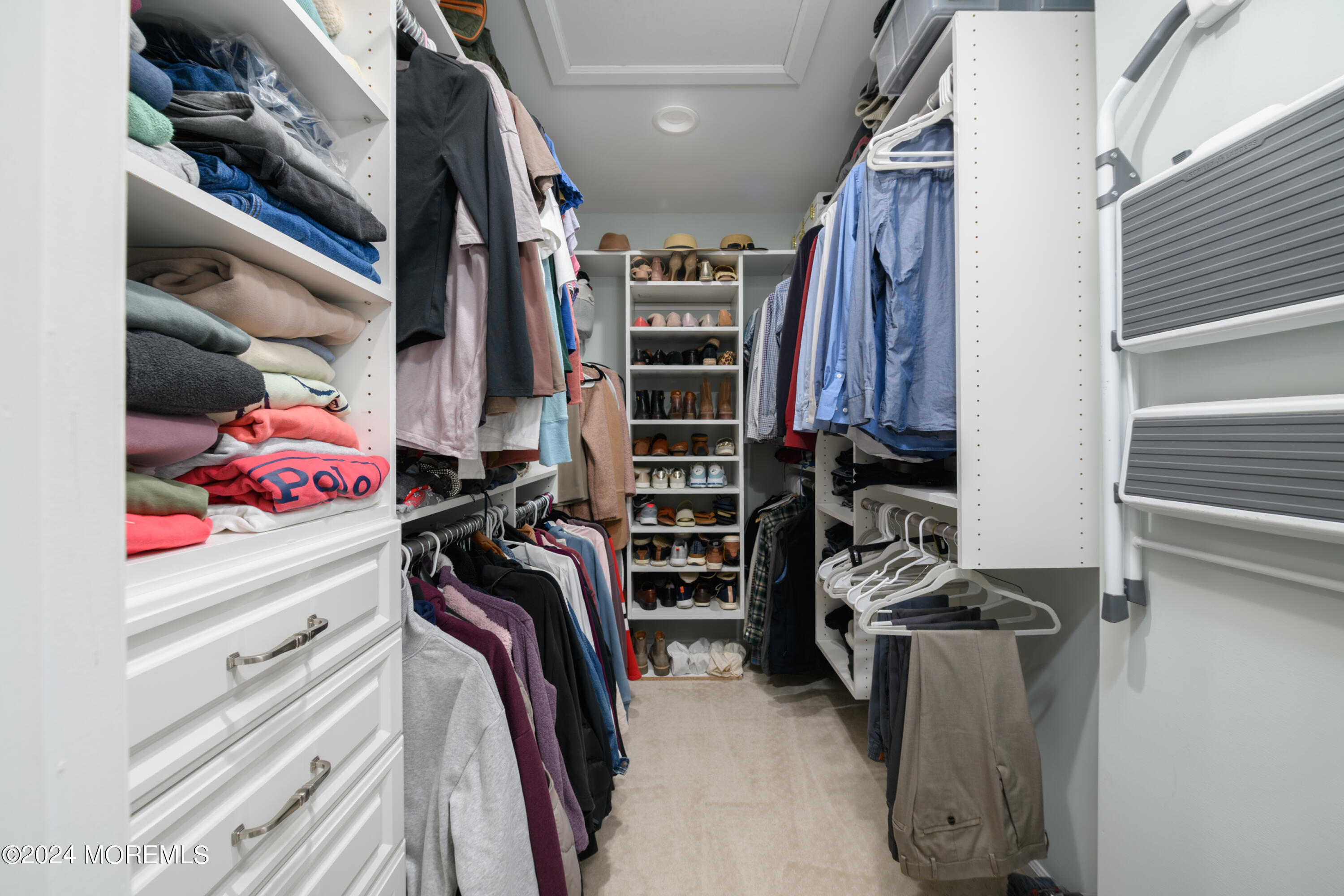 11 Exeter Pass Colts Neck, NJ 07722 - Photo 16 of 26 a view of walk in closet with clothes and shoes