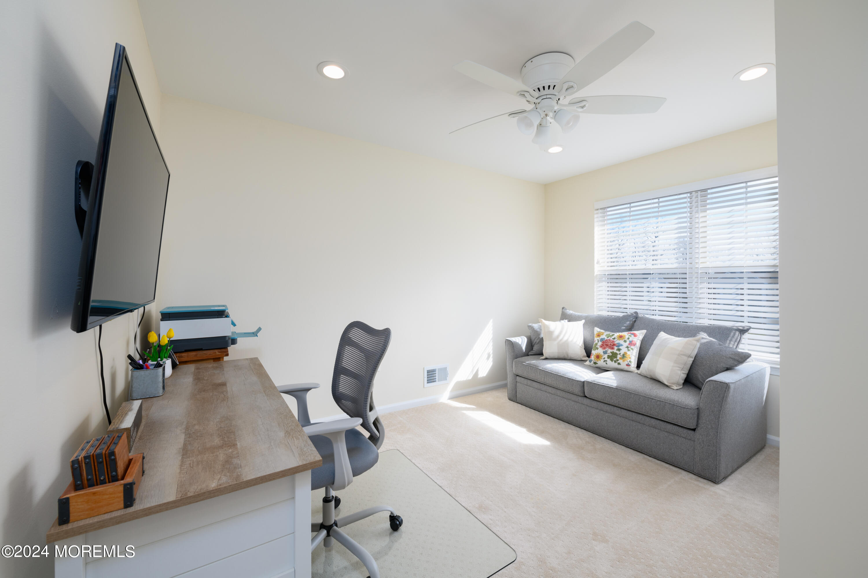 11 Exeter Pass Colts Neck, NJ 07722 - Photo 20 of 26 a living room with furniture and a flat screen tv