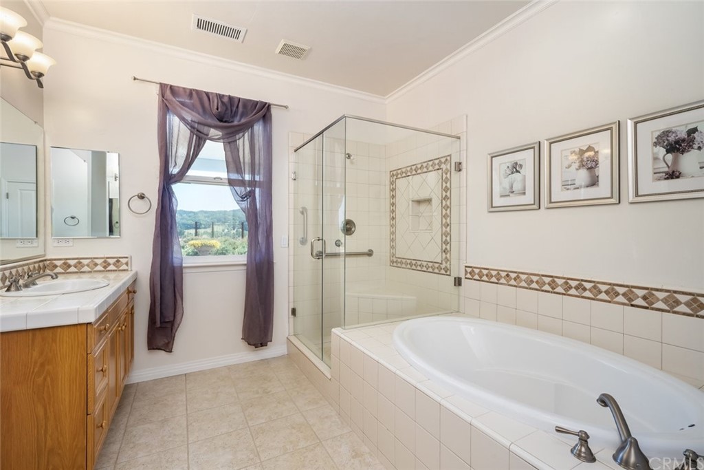 1675 Via Rojas Templeton, CA 93465 - Photo 29 of 60 a bathroom with a tub a sink and a shower