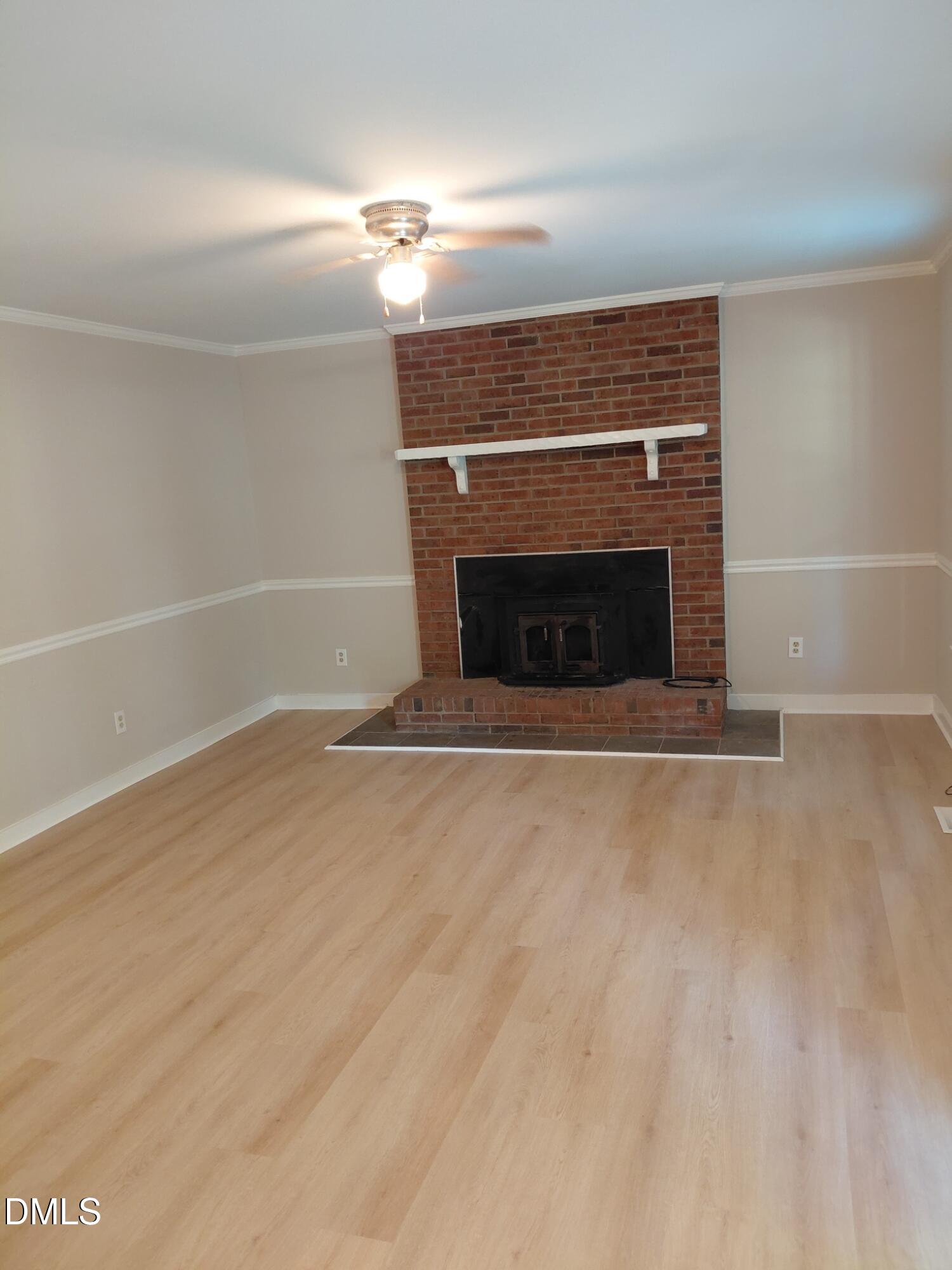 804 Olive Street Apex, NC 27502 - Photo 5 of 60 a view of empty room with a fireplace