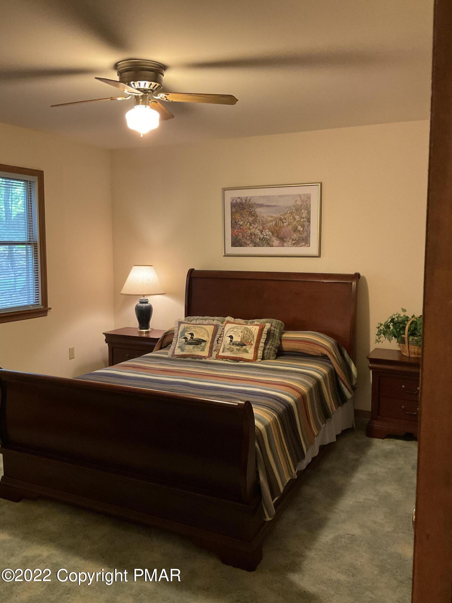 222 Brier Crest Road Blakeslee, PA 18610 - Photo 12 of 45 a bedroom with bed and lamps