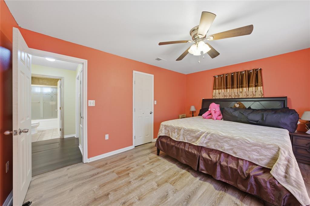 3624 Redbird Street Bellmead, TX 76705 - Photo 16 of 20 a bedroom with a bed and a chandelier
