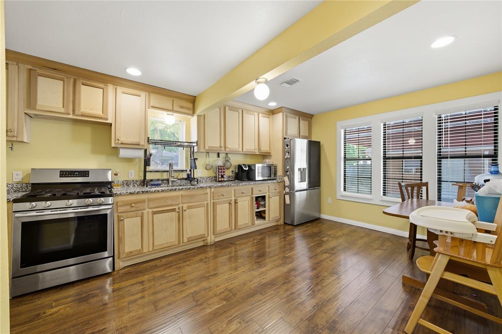 3624 Redbird Street Bellmead, TX 76705 - Photo 6 of 20 a kitchen with a stove a sink and a refrigerator