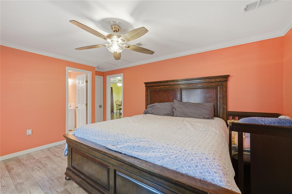 3624 Redbird Street Bellmead, TX 76705 - Photo 10 of 20 a bedroom with a bed and a chandelier