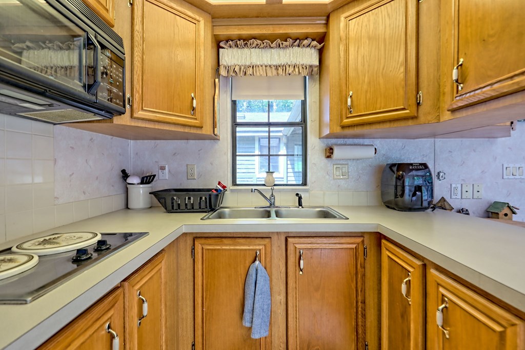 641 Cold Branch Road Hayesville, NC 28904 - Photo 30 of 65 a kitchen with a sink a stove cabinets and a wooden floor