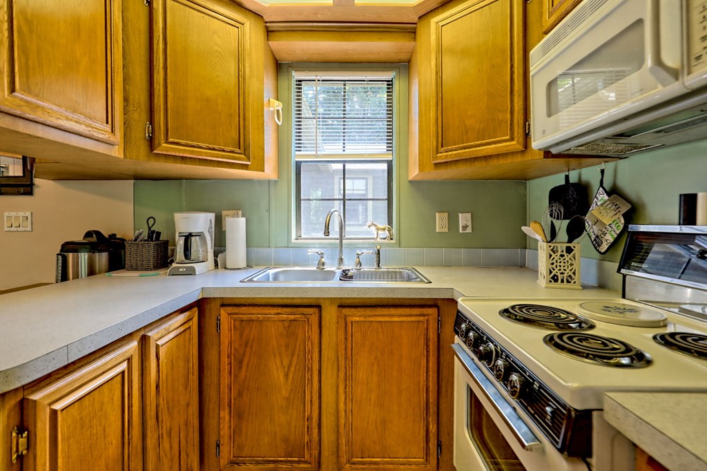641 Cold Branch Road Hayesville, NC 28904 - Photo 41 of 65 a kitchen with stainless steel appliances granite countertop a stove and a sink