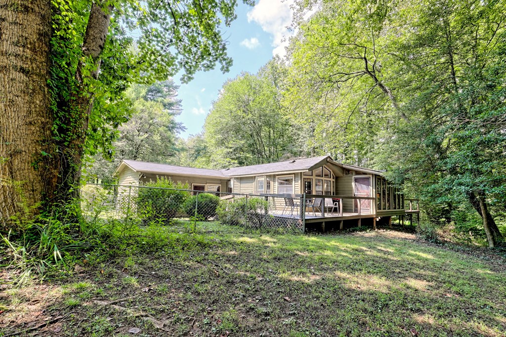 641 Cold Branch Road Hayesville, NC 28904 - Photo 55 of 65 a front view of a house with a garden and trees
