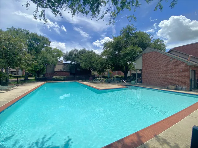 a living room with patio furniture and a large window