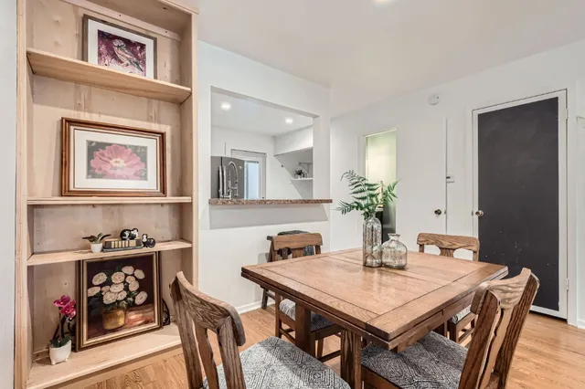 a view of a a dining room with furniture window and wooden floor