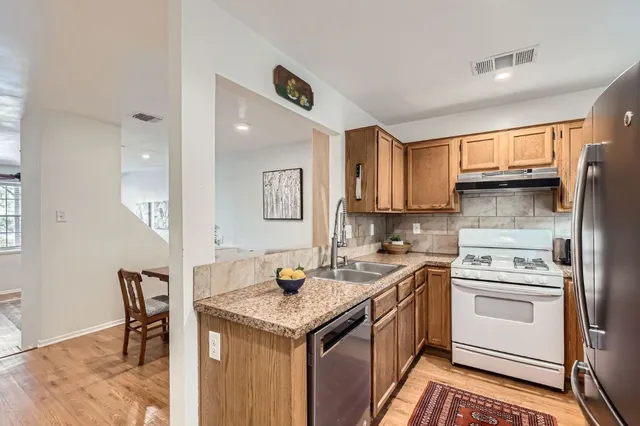 a kitchen with a sink stove and refrigerator