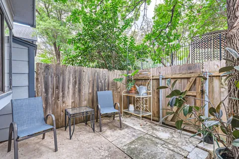 a view of a chairs and table in the back yard of the house