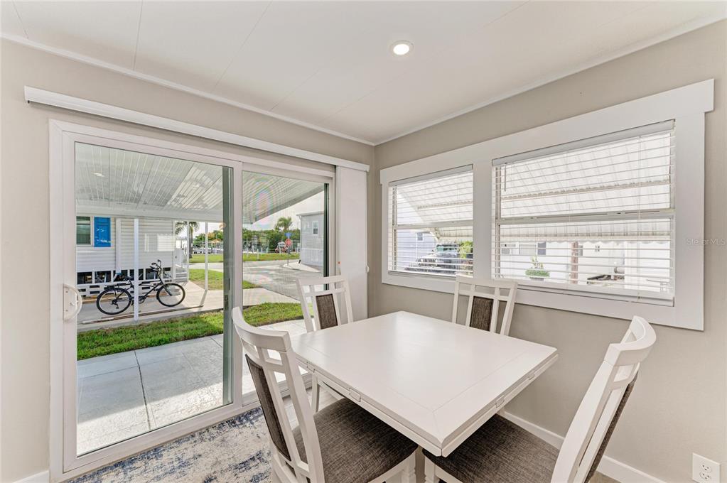 10315 Cortez Road West, Unit 61 Bradenton, FL 34210 - Photo 11 of 46 a view of a dining room with furniture window and wooden floor