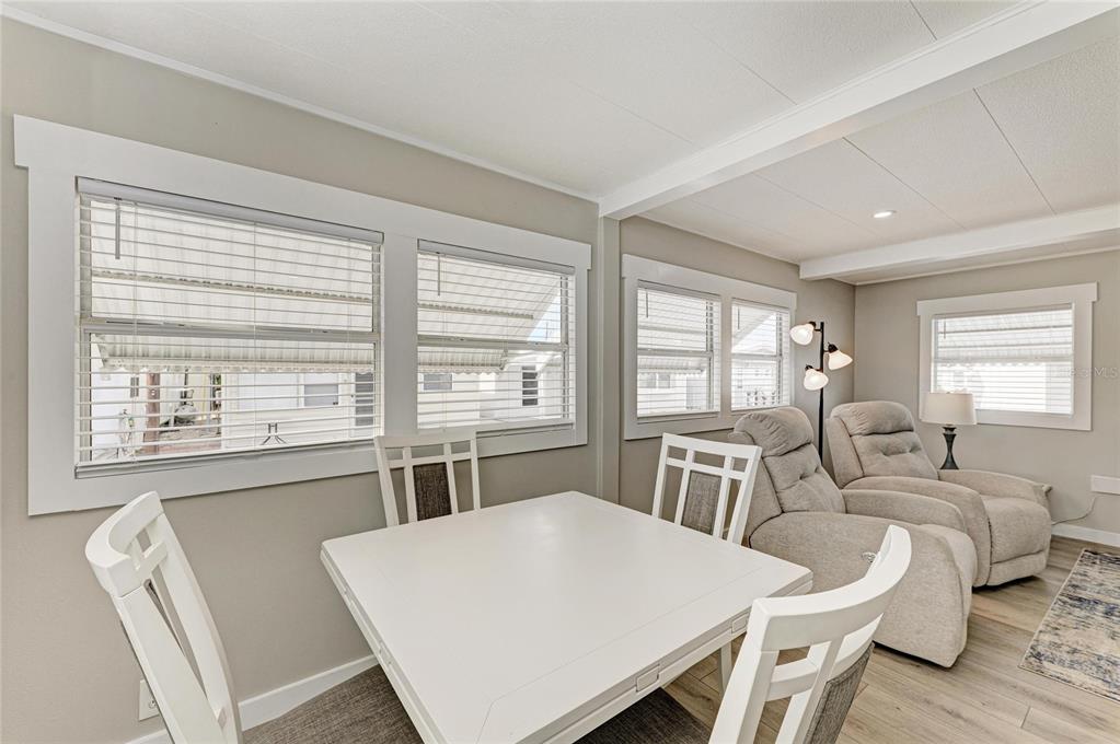 10315 Cortez Road West, Unit 61 Bradenton, FL 34210 - Photo 12 of 46 a living room with furniture a large window and a table