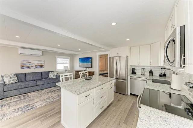 a kitchen with stainless steel appliances a stove a sink and a refrigerator