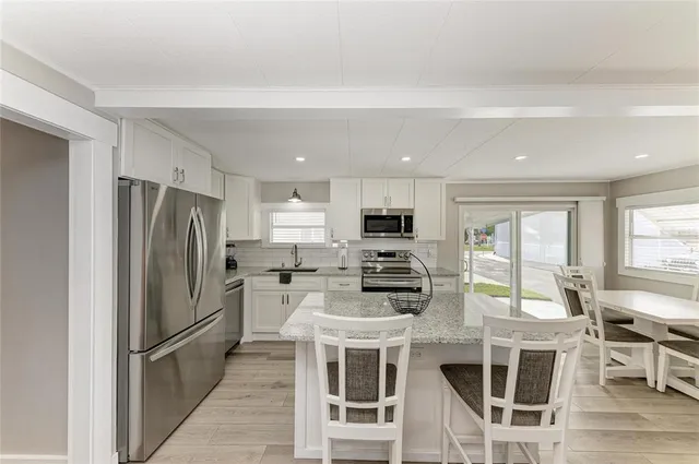 a kitchen with a stove a sink and a microwave
