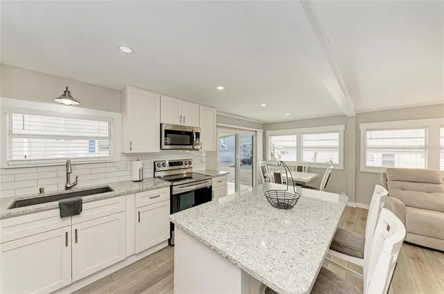 a large kitchen with a table and chairs