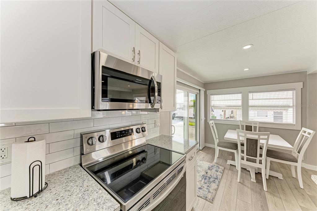 10315 Cortez Road West, Unit 61 Bradenton, FL 34210 - Photo 17 of 46 a kitchen with a stove a sink and a microwave