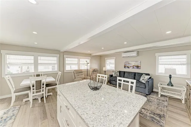 a living room with furniture flat screen tv and outdoor view
