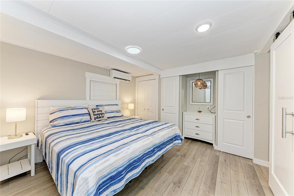 10315 Cortez Road West, Unit 61 Bradenton, FL 34210 - Photo 21 of 46 a bedroom with double bed and three windows