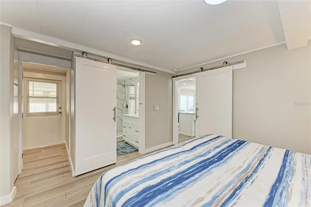 a bedroom with a bed and a mirror