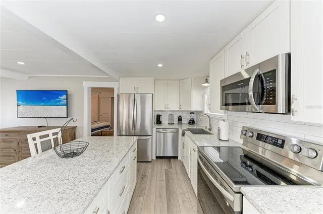 a living room with furniture and kitchen view