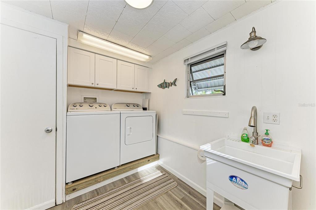 10315 Cortez Road West, Unit 61 Bradenton, FL 34210 - Photo 31 of 46 a utility room with cabinets washer and dryer