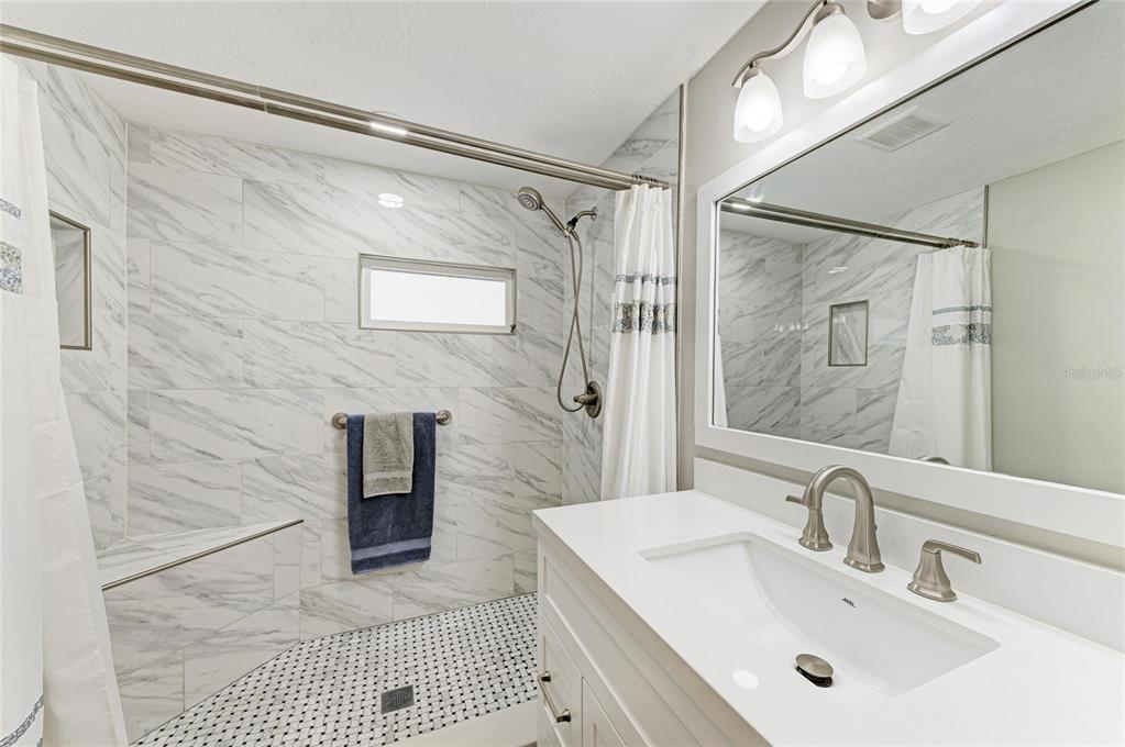 10315 Cortez Road West, Unit 61 Bradenton, FL 34210 - Photo 5 of 46 a bathroom with a sink mirror and a shower