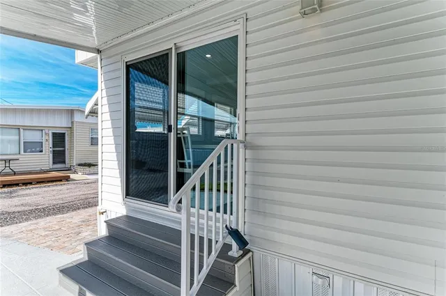 a living room with furniture a large window and a table