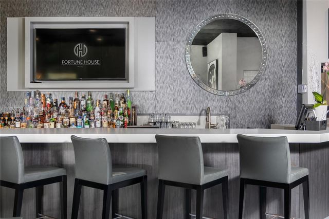 a dining room with a sink table and chairs
