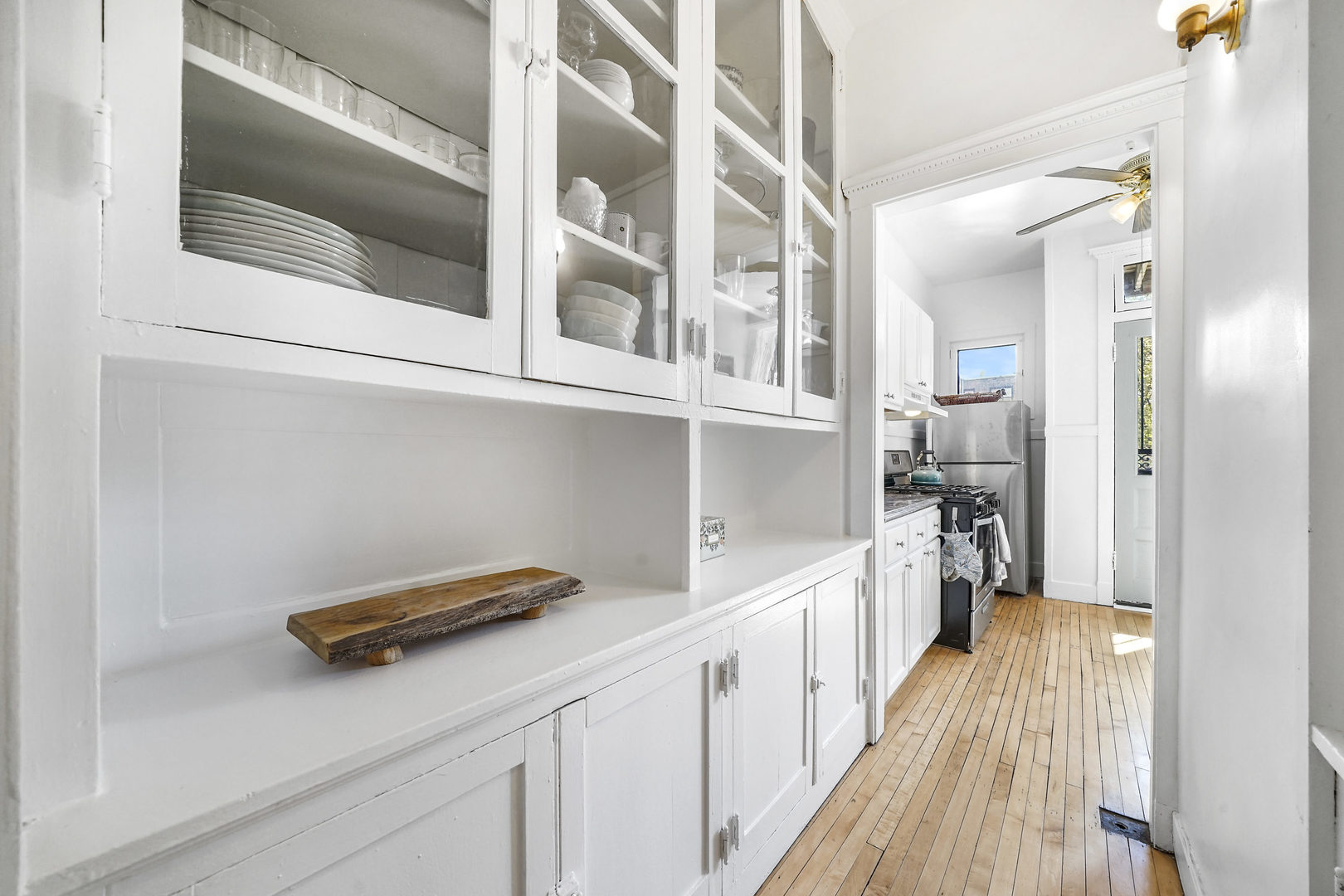 5707 South Blackstone Avenue, Unit 2 Chicago, IL 60637 - Photo 11 of 25 a hallway with a white cabinets and wooden floor
