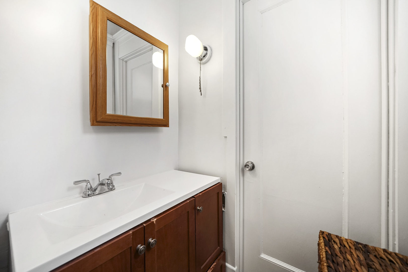 5707 South Blackstone Avenue, Unit 2 Chicago, IL 60637 - Photo 14 of 25 a bathroom with a sink and a mirror