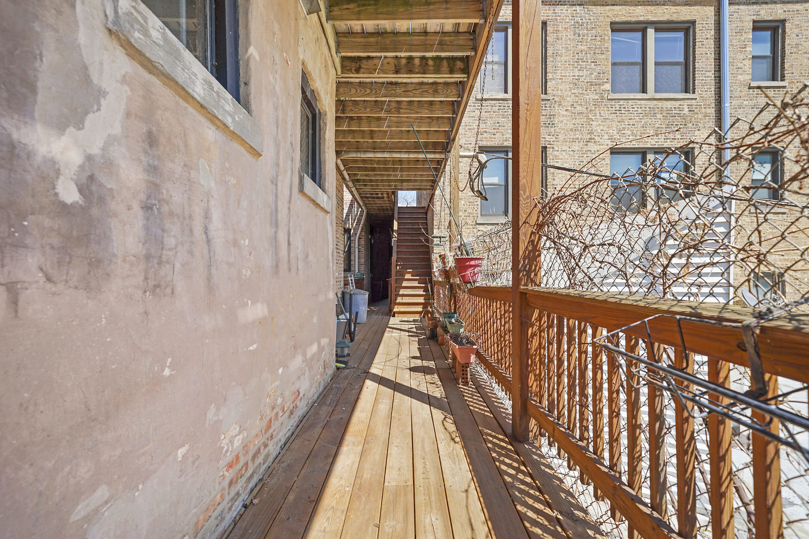 5707 South Blackstone Avenue, Unit 2 Chicago, IL 60637 - Photo 24 of 25 a view of balcony with wooden floor and floor to ceiling window