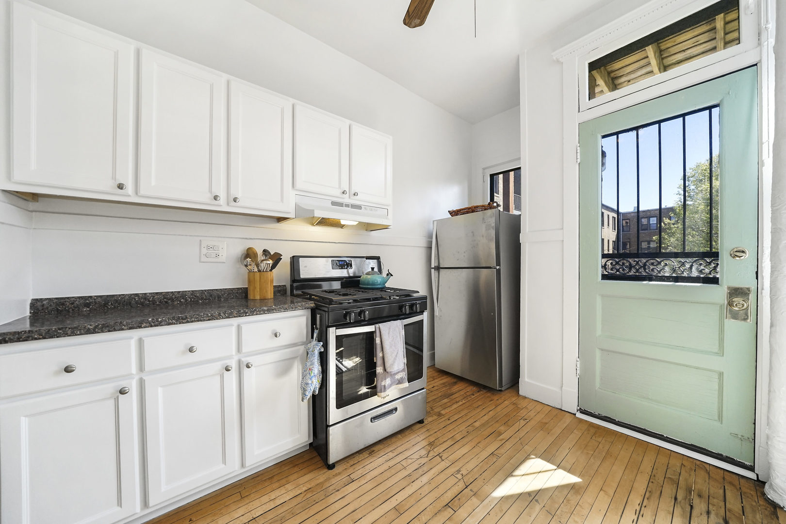 5707 South Blackstone Avenue, Unit 2 Chicago, IL 60637 - Photo 9 of 25 a kitchen with granite countertop white cabinets and stainless steel appliances