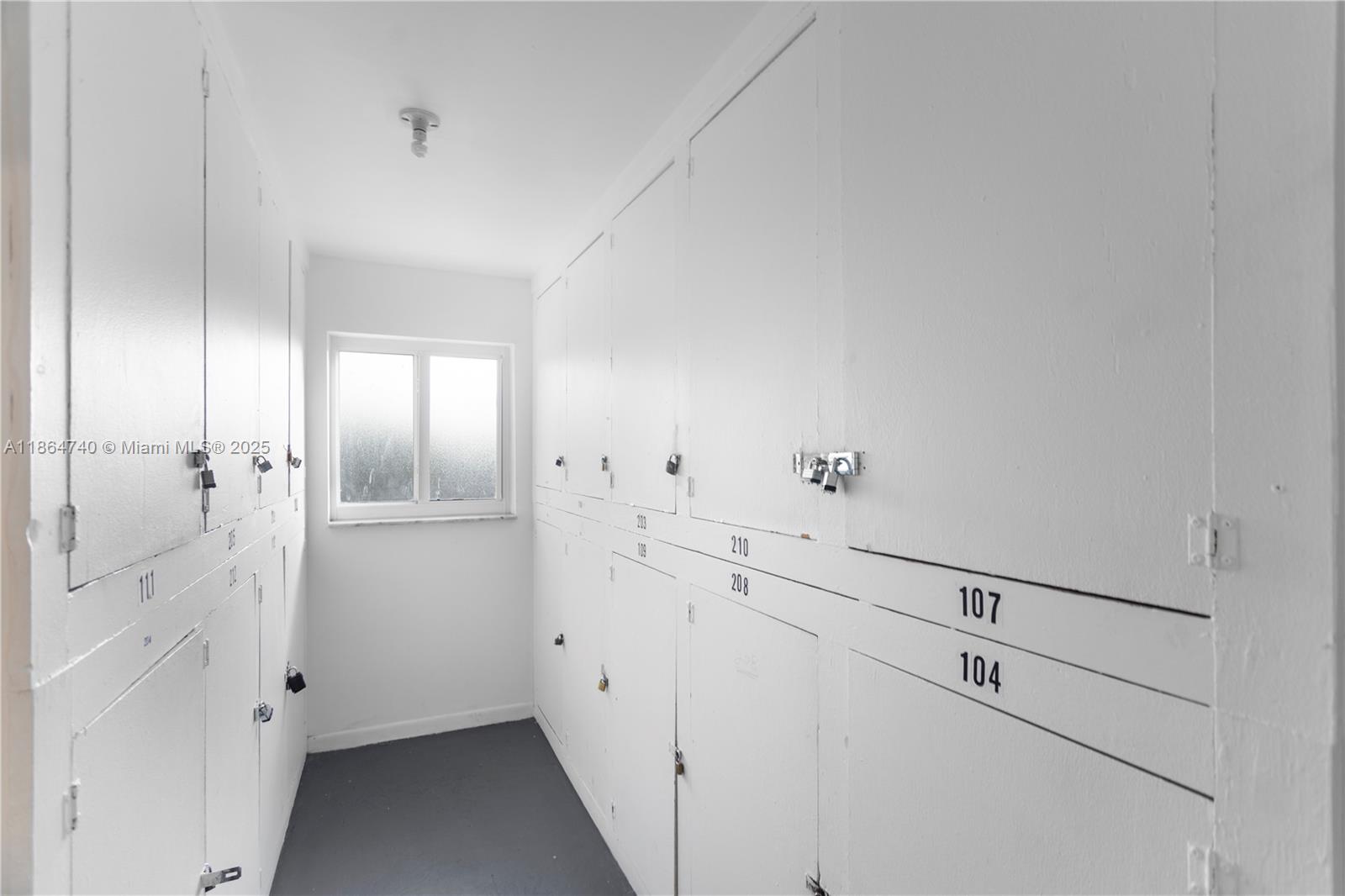 701 Northeast 1st Court, Unit 209 Hallandale Beach, FL 33009 - Photo 16 of 39 a view of a hallway with white cabinets