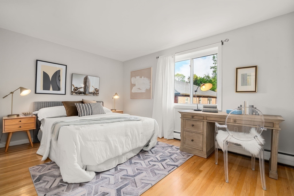 205 Kent Street, Unit 48 Brookline, MA 02446 - Photo 9 of 10 a bedroom with a bed and a desk