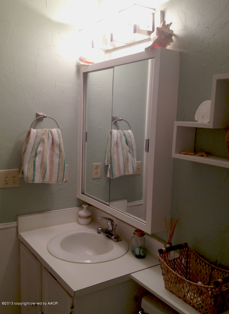 8213 Goodnight Trail Amarillo, TX 79110 - Photo 14 of 20 a bathroom with a sink vanity and a mirror